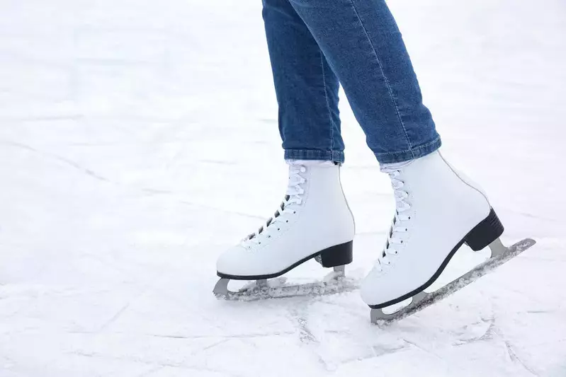 Woman,Wearing,Figure,Skates,On,Ice,Rink,,Closeup.,Space,For