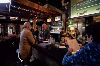 A bartender chats with a customer